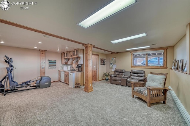 living room with recessed lighting, baseboards, ornate columns, indoor bar, and light colored carpet