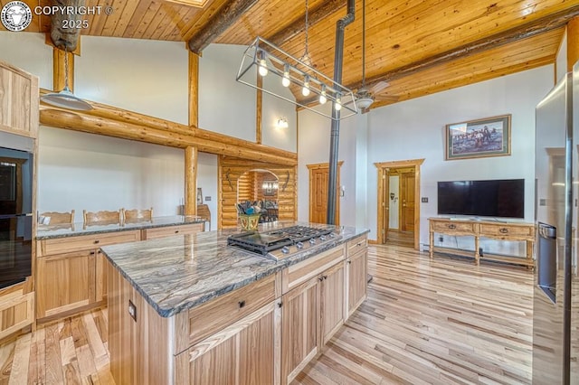 kitchen with light brown cabinetry, high vaulted ceiling, stainless steel gas cooktop, and wooden ceiling