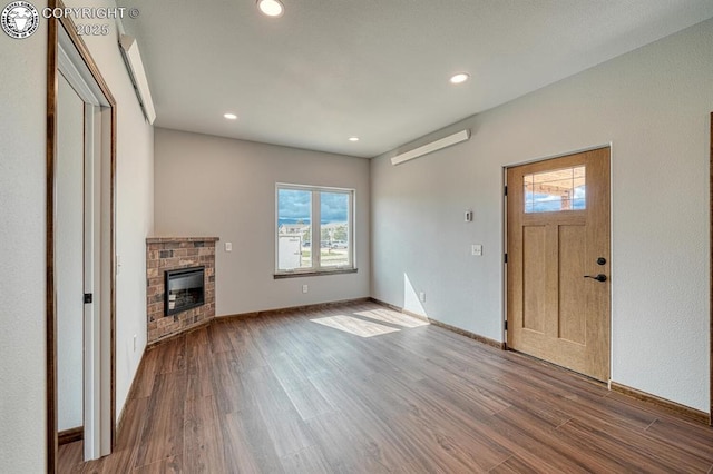 806 S St, Silver Cliff, CO 81252 - unfurnished living room with wood finished floors, plenty of natural light, a fireplace, recessed lighting, and baseboards