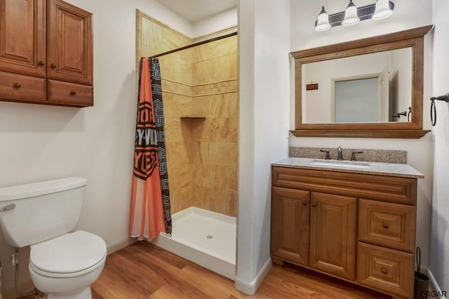 bathroom with vanity, hardwood / wood-style floors, curtained shower, and toilet