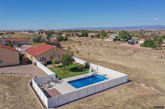 view of swimming pool with a mountain view