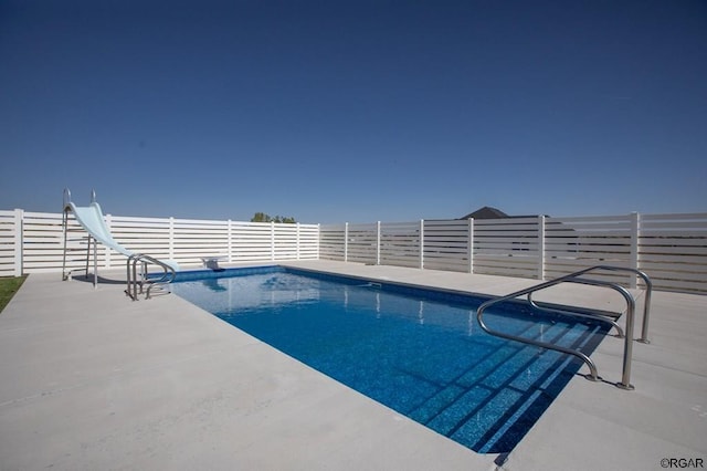 view of swimming pool featuring a patio and a water slide