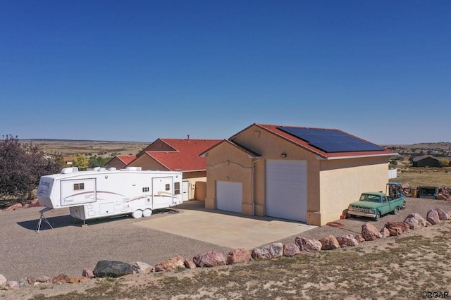 view of front of home featuring solar panels