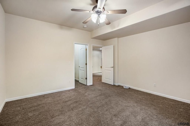 unfurnished bedroom featuring ceiling fan and dark colored carpet