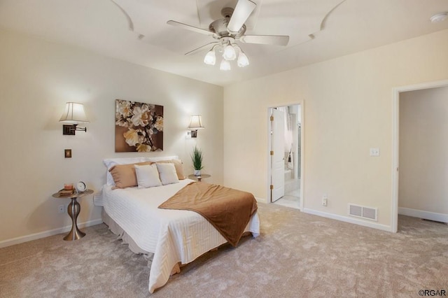 bedroom featuring light carpet, connected bathroom, and ceiling fan