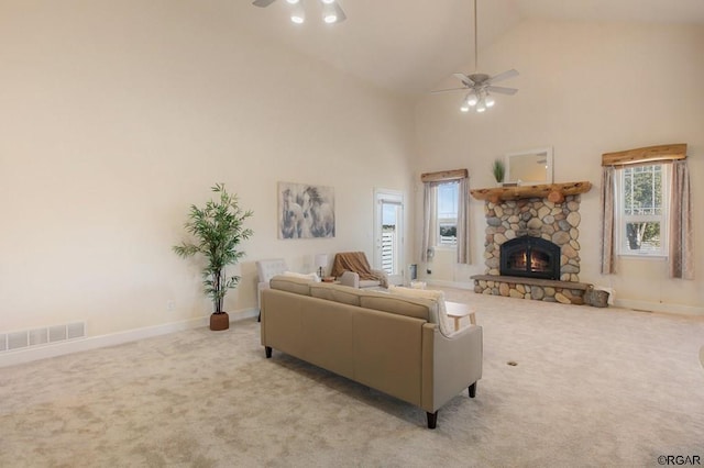 carpeted living room featuring ceiling fan, a fireplace, and high vaulted ceiling