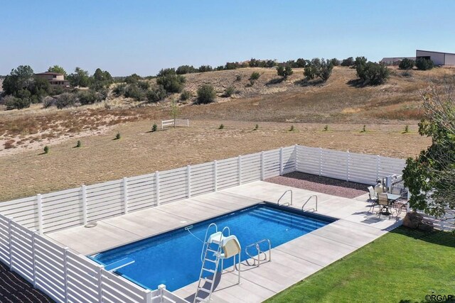 view of swimming pool with a patio area