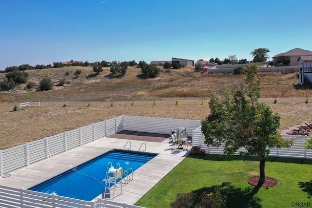 view of pool featuring a water slide, a patio area, and a lawn