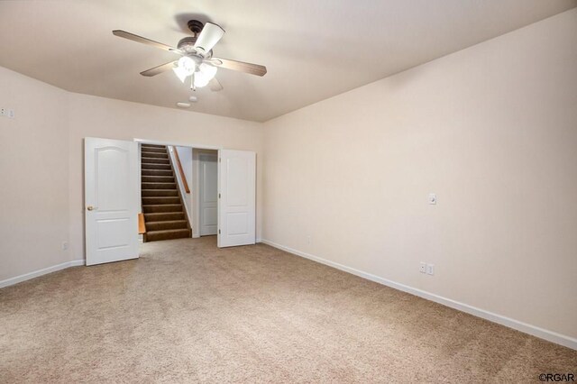 unfurnished bedroom with carpet floors and ceiling fan