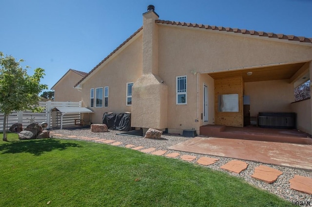 back of house with a yard and a patio