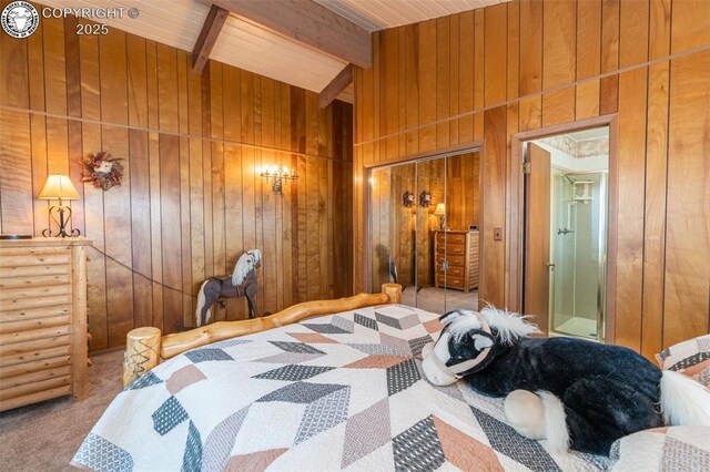 carpeted bedroom with wood ceiling, a closet, beamed ceiling, and wood walls