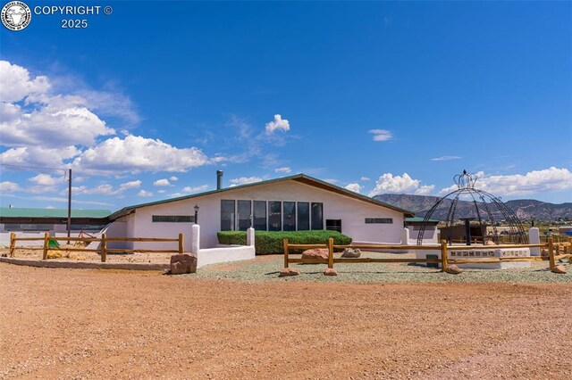 rear view of property featuring a mountain view