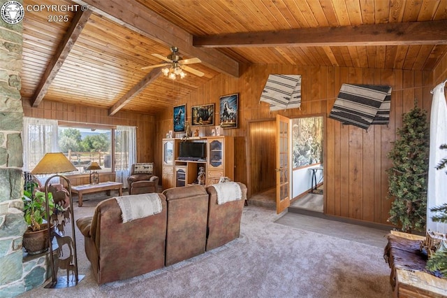 carpeted living room with wood ceiling, wooden walls, lofted ceiling with beams, and ceiling fan