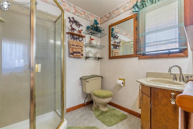 bathroom with toilet, vanity, and a shower with shower door