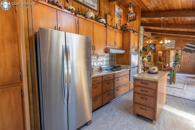 kitchen featuring vaulted ceiling with beams, wood ceiling, decorative light fixtures, stainless steel appliances, and backsplash