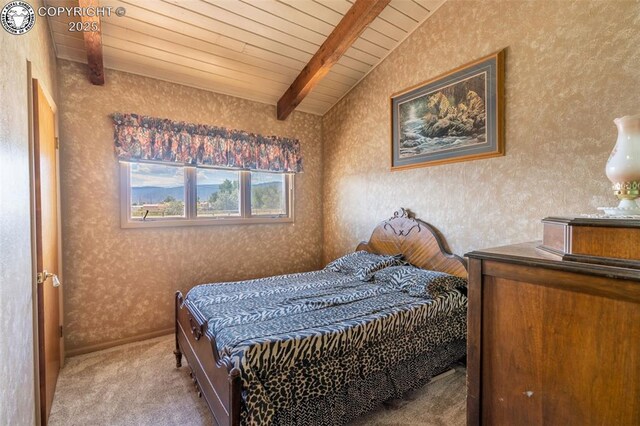 carpeted bedroom featuring lofted ceiling with beams and wood ceiling