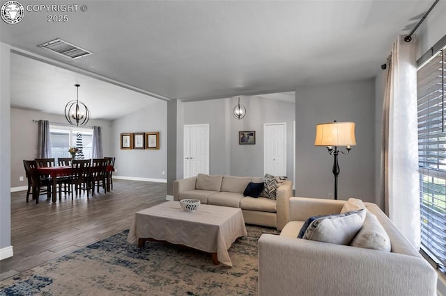 717 Tyrolean Way, Canon City, CO 81212 - living room with a chandelier, dark wood-type flooring, and baseboards