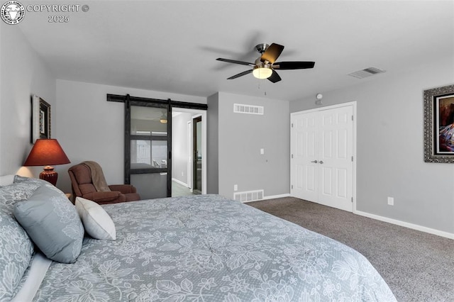 717 Tyrolean Way, Canon City, CO 81212 - bedroom featuring a barn door, carpet flooring, baseboards, and a ceiling fan