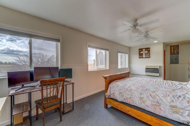 bedroom with heating unit, electric panel, ceiling fan, and dark colored carpet