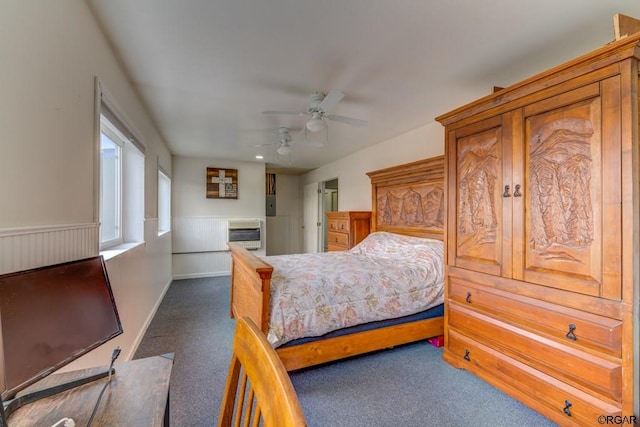 carpeted bedroom featuring heating unit and ceiling fan