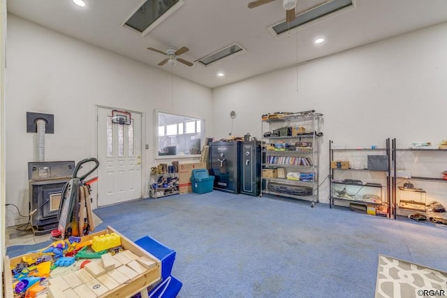 garage featuring ceiling fan and a wood stove