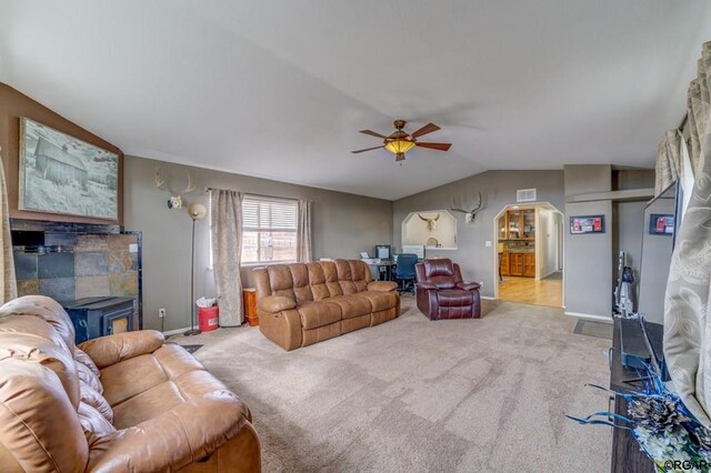 carpeted living room with vaulted ceiling and ceiling fan