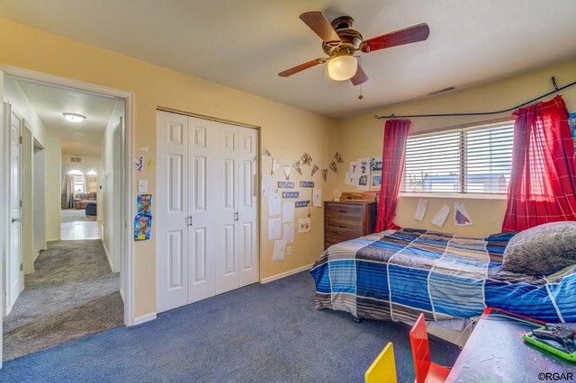 bedroom with carpet, ceiling fan, and a closet