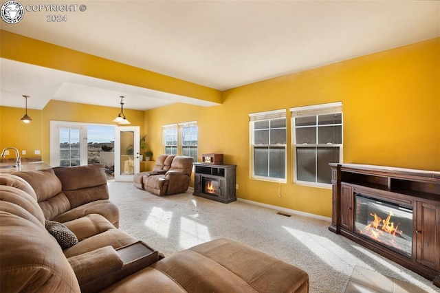 carpeted living room featuring a fireplace