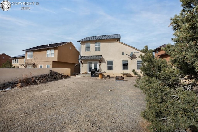 back of house featuring a fire pit