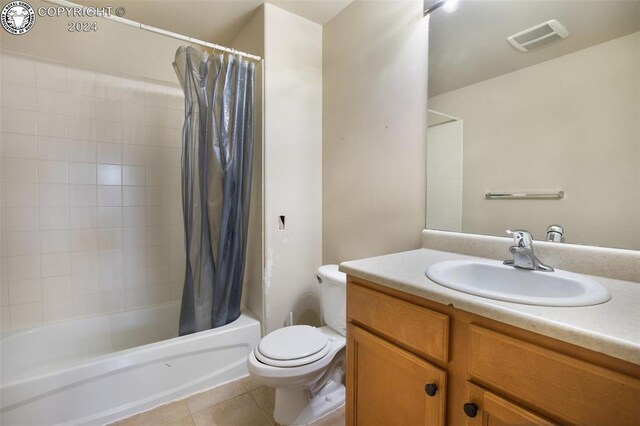 full bathroom with tile patterned flooring, vanity, shower / tub combo, and toilet