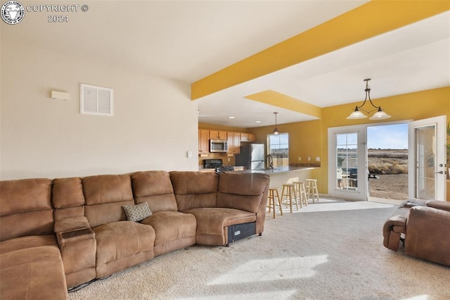 living room with sink and light carpet