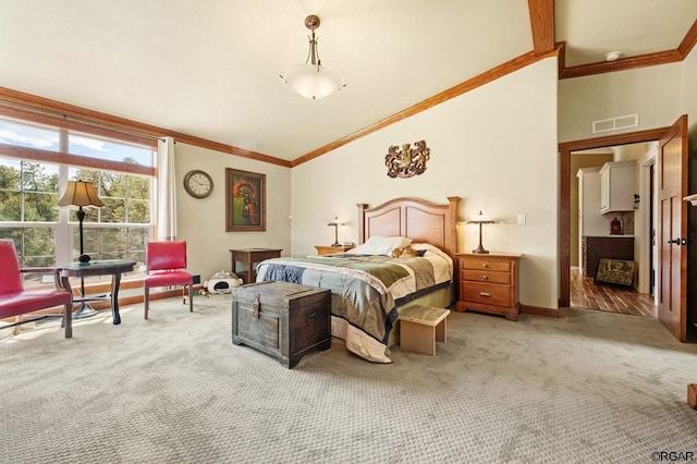 carpeted bedroom with ornamental molding and lofted ceiling