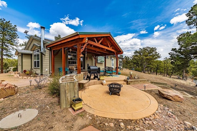 back of property featuring an outdoor fire pit