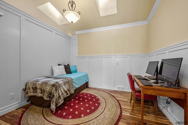 bedroom featuring hardwood / wood-style flooring and ornamental molding