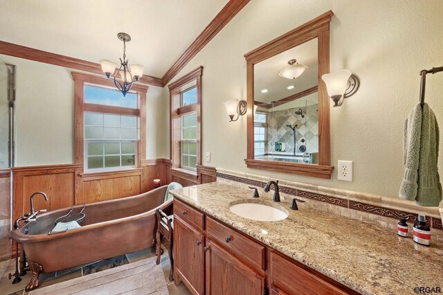 bathroom featuring lofted ceiling, a chandelier, ornamental molding, separate shower and tub, and vanity