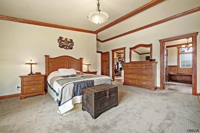 bedroom with a walk in closet, vaulted ceiling, ornamental molding, a closet, and light colored carpet