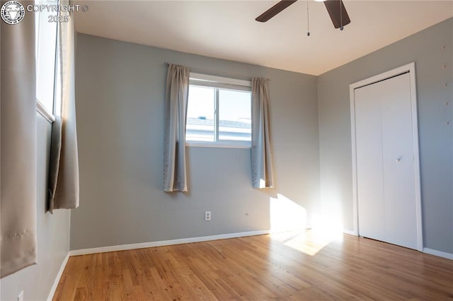 unfurnished bedroom featuring ceiling fan and light wood-type flooring