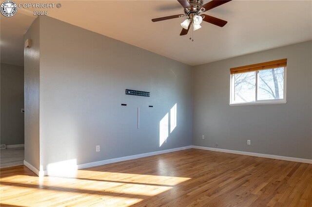 spare room with light hardwood / wood-style floors and ceiling fan