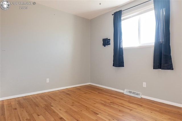 unfurnished room with light wood-type flooring