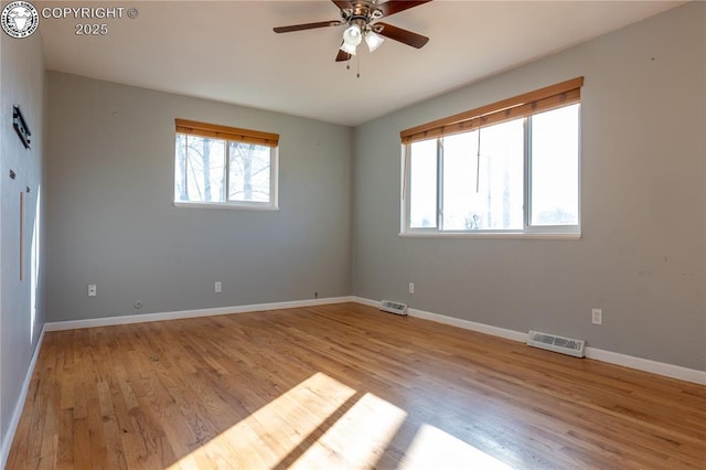 empty room with ceiling fan and light wood-type flooring