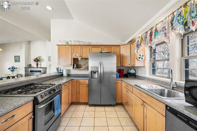 kitchen featuring sink, light tile patterned floors, vaulted ceiling, and appliances with stainless steel finishes