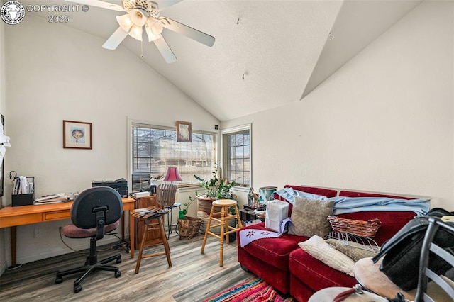 office space featuring hardwood / wood-style floors, high vaulted ceiling, and ceiling fan