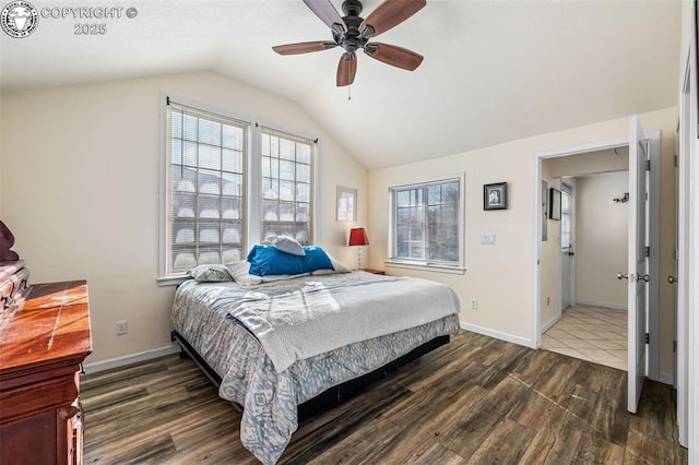 bedroom featuring lofted ceiling, dark wood-type flooring, and ceiling fan