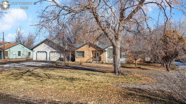 view of front of house with a garage and a front yard