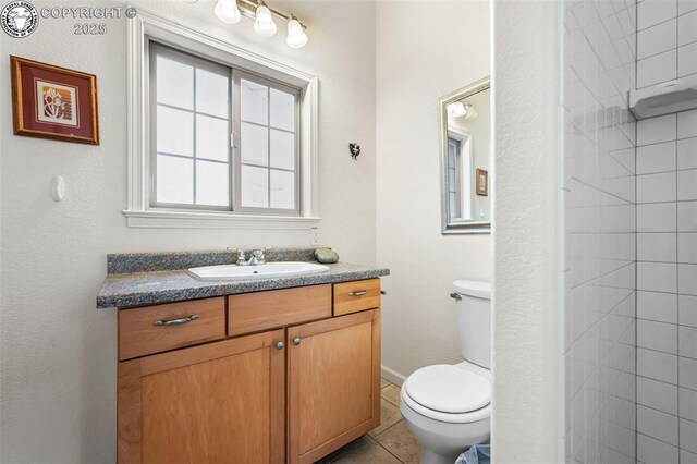 bathroom featuring tile patterned floors, toilet, and vanity