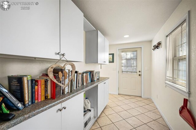 doorway to outside with light tile patterned floors and a wealth of natural light