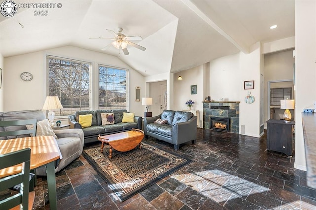 living room featuring ceiling fan, lofted ceiling, and a fireplace