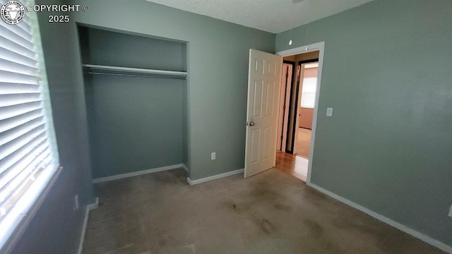 305 Meadowlark Cir, Florence, CO 81226 - unfurnished bedroom featuring carpet flooring, a closet, and baseboards