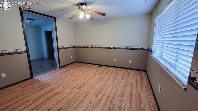 305 Meadowlark Cir, Florence, CO 81226 - empty room with a ceiling fan, light wood-style flooring, healthy amount of natural light, a textured ceiling, and baseboards
