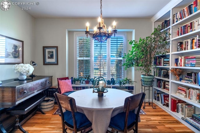 dining area featuring a notable chandelier and light hardwood / wood-style floors